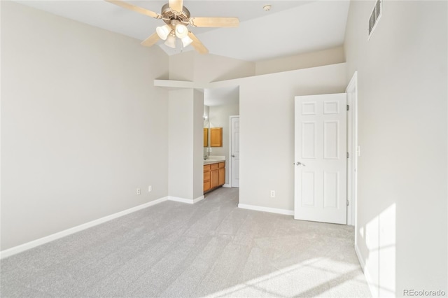 unfurnished bedroom with light colored carpet and ensuite bath