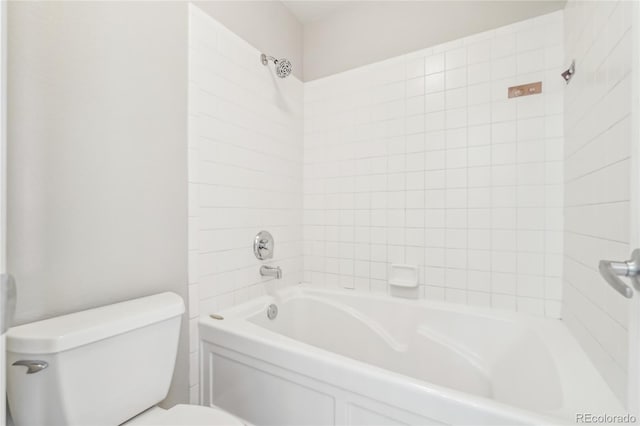 bathroom with toilet and tiled shower / bath combo