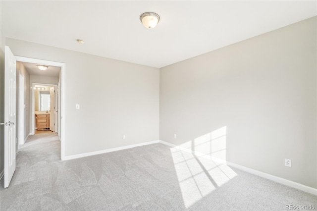 unfurnished room featuring light carpet