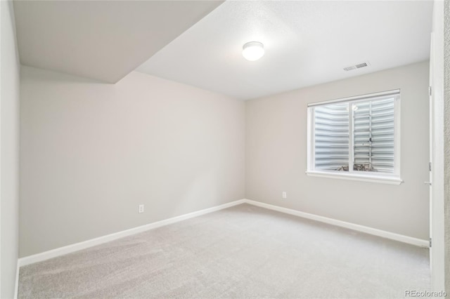 empty room featuring light carpet