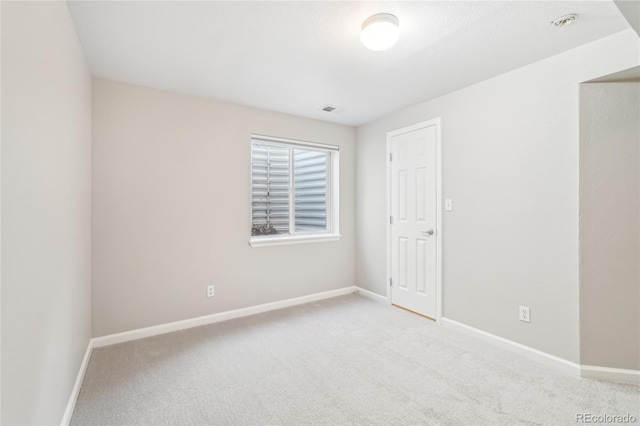 unfurnished room with light carpet