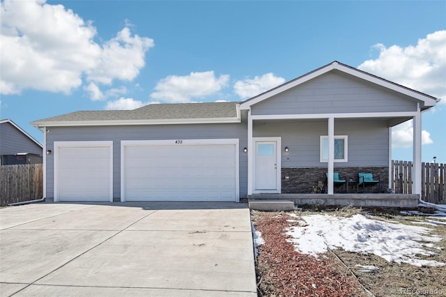 single story home with a porch and a garage