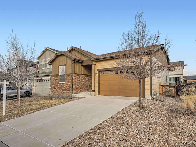 view of front of home with board and batten siding, concrete driveway, stone siding, and a garage