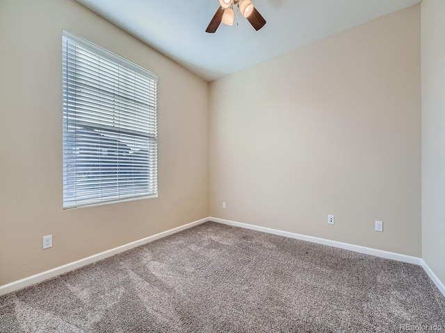 spare room with carpet floors, ceiling fan, and baseboards