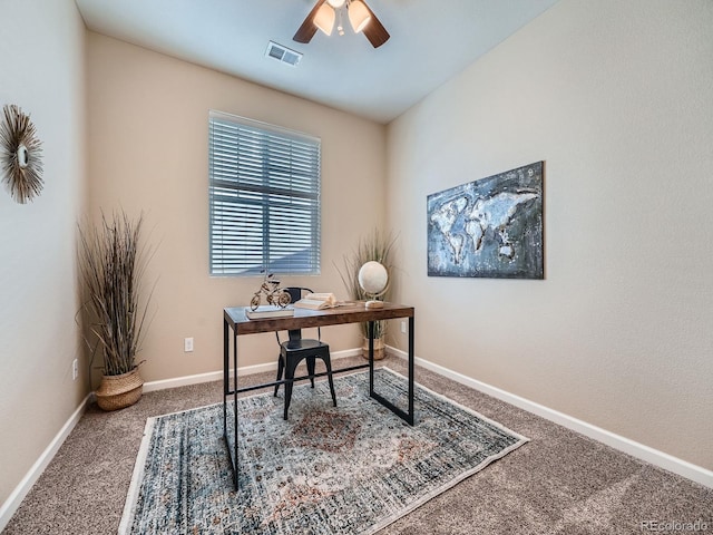 office space featuring a ceiling fan, carpet, visible vents, and baseboards