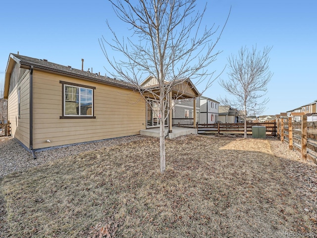 back of house featuring a fenced backyard and a patio