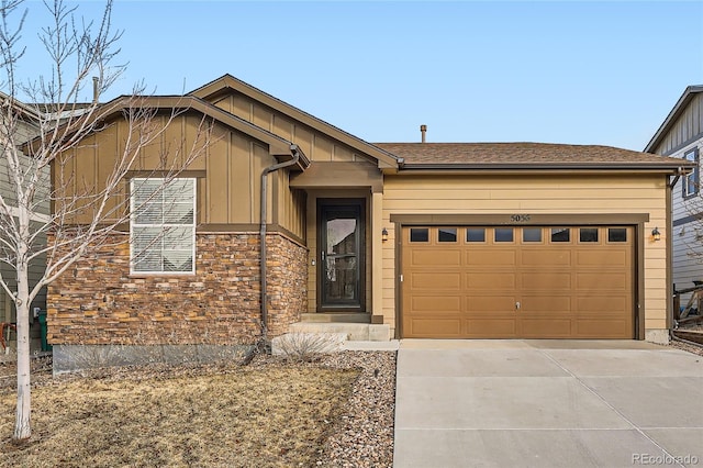 single story home featuring an attached garage, stone siding, driveway, and board and batten siding