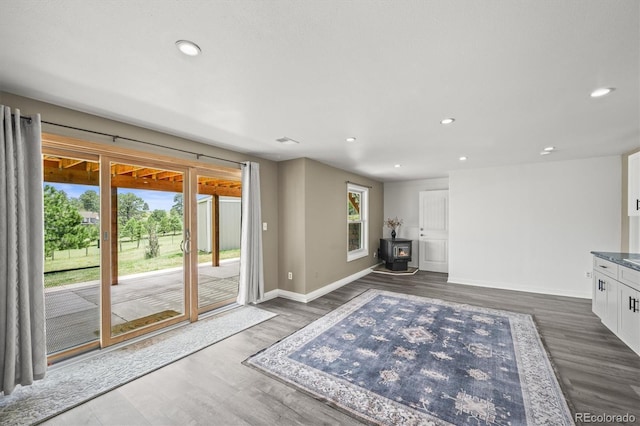 1233 Starling Ln, Elizabeth, CO 80107 - unfurnished living room with a wood stove, recessed lighting, and dark wood-style flooring
