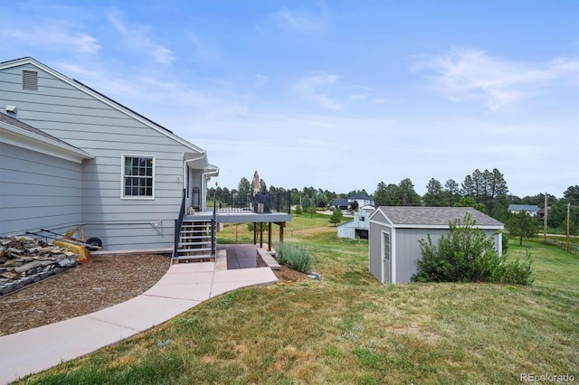 1233 Starling Ln, Elizabeth, CO 80107 - view of green lawn featuring stairs, a deck, and a shed