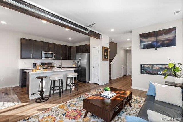 living room featuring dark hardwood / wood-style floors and sink