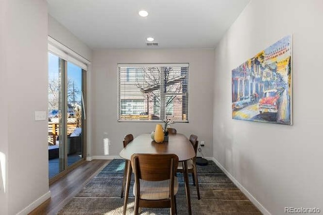 dining area with dark hardwood / wood-style flooring