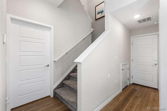 stairway featuring hardwood / wood-style flooring