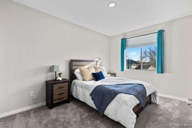 bedroom featuring dark carpet