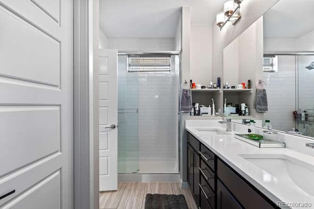 bathroom with walk in shower and vanity