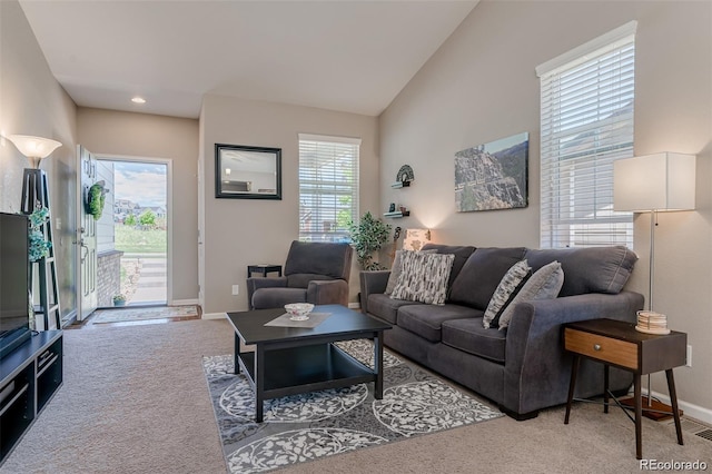 living room with lofted ceiling, baseboards, and carpet flooring