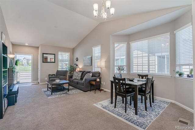 dining area with lofted ceiling, a notable chandelier, a wealth of natural light, and light colored carpet