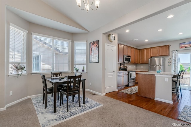 dining room with lofted ceiling, baseboards, a notable chandelier, and dark colored carpet