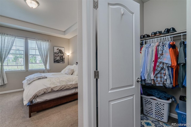 bedroom featuring baseboards and carpet flooring