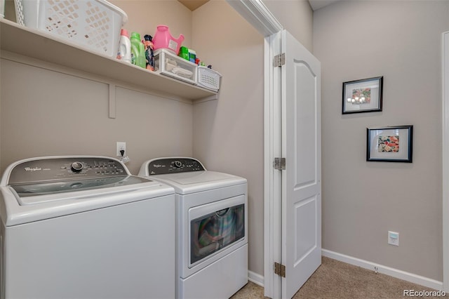 laundry room with light carpet, laundry area, washing machine and dryer, and baseboards