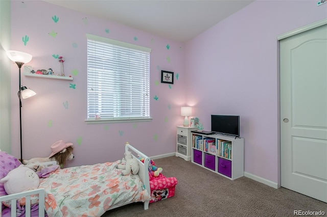 bedroom featuring light colored carpet and baseboards