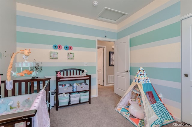 bedroom featuring light carpet, attic access, and visible vents