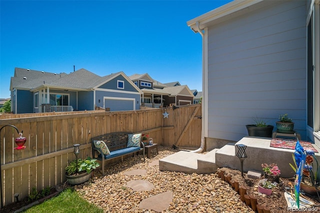 view of yard with a garage and fence