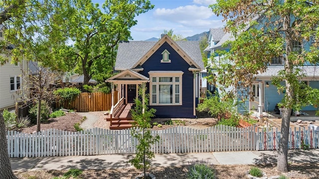 2119 W Pikes Peak Ave, Colorado Springs, CO 80904 - view of front of home with a fenced front yard and a shingled roof