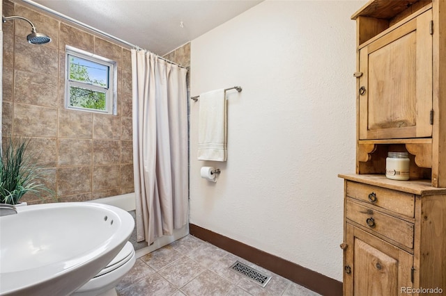 2119 W Pikes Peak Ave, Colorado Springs, CO 80904 - full bathroom with shower / tub combo, baseboards, tile patterned flooring, and toilet