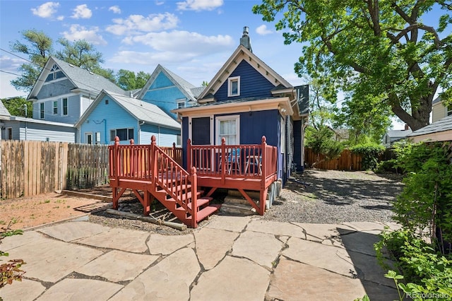2119 W Pikes Peak Ave, Colorado Springs, CO 80904 - rear view of house featuring a fenced backyard, a deck, a patio, and a chimney