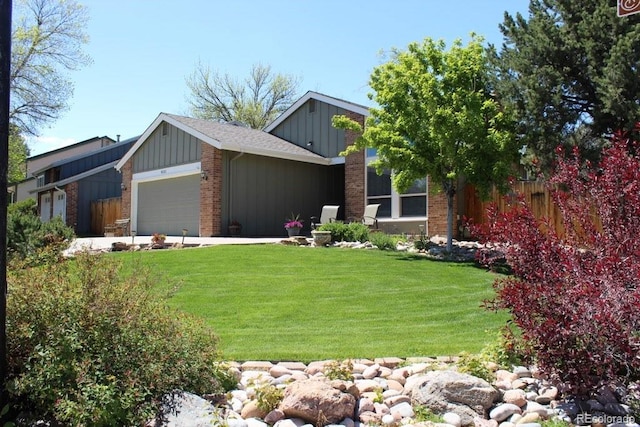 8101 S San Juan Range Rd, Littleton, CO 80127 - view of front facade with board and batten siding, a garage, and brick siding