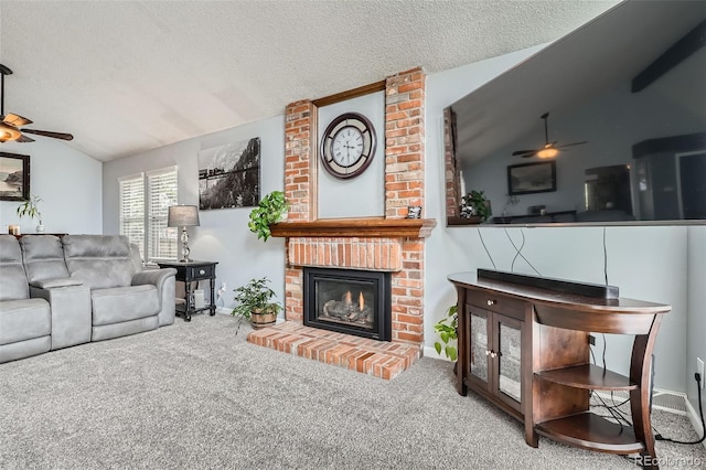 8101 S San Juan Range Rd, Littleton, CO 80127 - carpeted living area with ceiling fan, vaulted ceiling, a fireplace, a textured ceiling, and baseboards