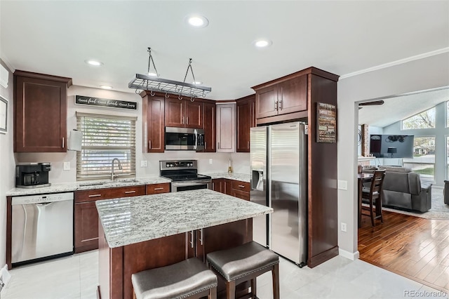 8101 S San Juan Range Rd, Littleton, CO 80127 - kitchen with stainless steel appliances, a sink, healthy amount of natural light, light stone countertops, and recessed lighting
