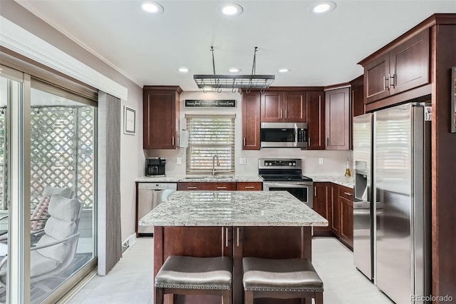 8101 S San Juan Range Rd, Littleton, CO 80127 - kitchen with stainless steel appliances, a sink, recessed lighting, light stone counters, and a center island