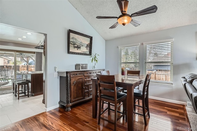 8101 S San Juan Range Rd, Littleton, CO 80127 - dining space featuring lofted ceiling, ceiling fan, baseboards, a textured ceiling, and wood finished floors