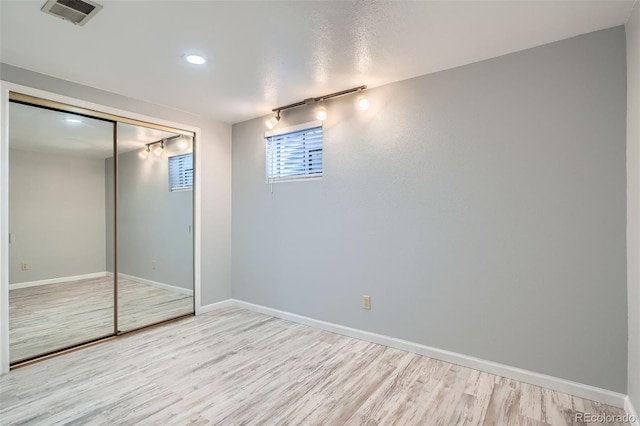 8101 S San Juan Range Rd, Littleton, CO 80127 - unfurnished bedroom with wood finished floors, baseboards, rail lighting, a closet, and recessed lighting