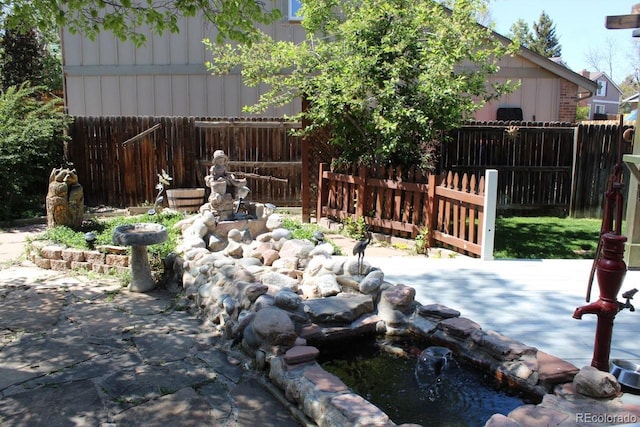 8101 S San Juan Range Rd, Littleton, CO 80127 - view of yard featuring a small pond and a patio area
