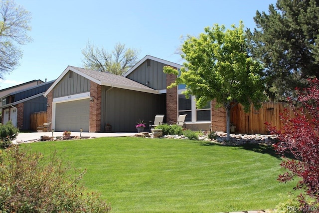 8101 S San Juan Range Rd, Littleton, CO 80127 - view of front of property with board and batten siding, an attached garage, brick siding, and driveway