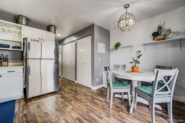 kitchen featuring white cabinetry, pendant lighting, open shelves, and freestanding refrigerator