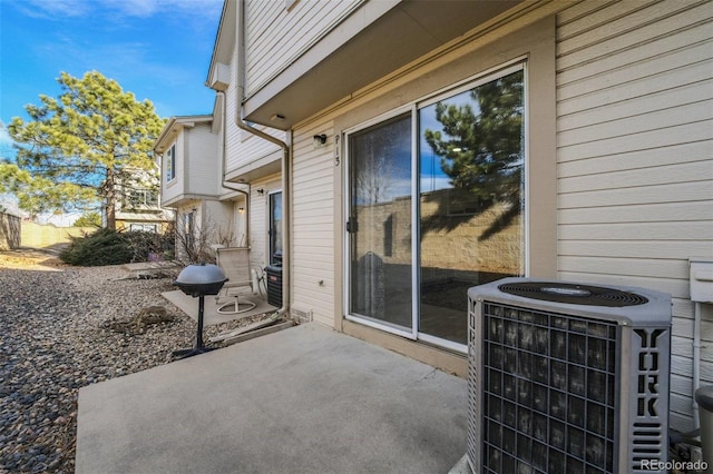 view of patio / terrace featuring cooling unit and a grill