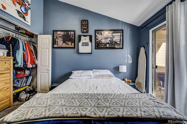 bedroom with vaulted ceiling and a closet