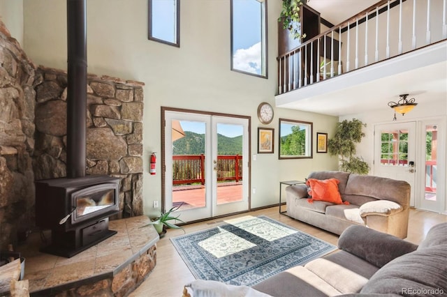 32392 Lodgepole Dr, Evergreen, CO 80439 - living area with a wood stove, a high ceiling, and wood finished floors