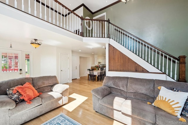 32392 Lodgepole Dr, Evergreen, CO 80439 - living room with wood finished floors, stairs, crown molding, a towering ceiling, and recessed lighting