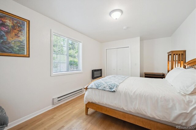 32392 Lodgepole Dr, Evergreen, CO 80439 - bedroom with a baseboard heating unit, light wood finished floors, and a closet
