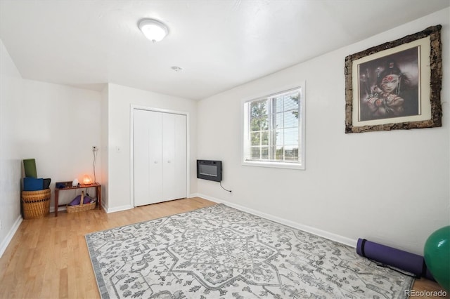 32392 Lodgepole Dr, Evergreen, CO 80439 - bedroom featuring heating unit, light wood-type flooring, and a closet