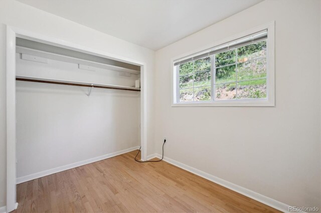 32392 Lodgepole Dr, Evergreen, CO 80439 - unfurnished bedroom with light wood-type flooring and a closet