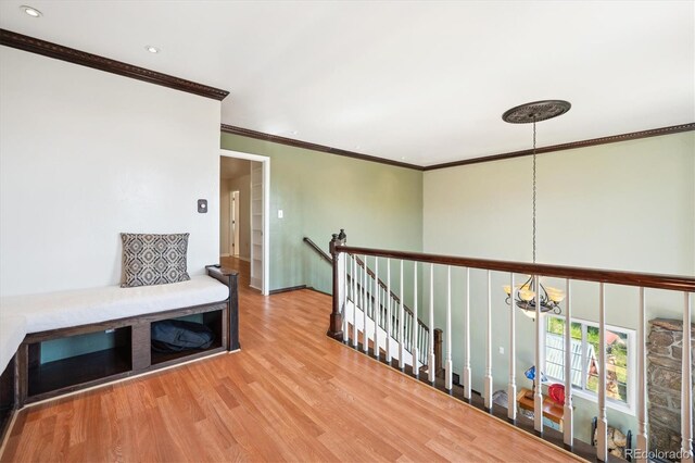 32392 Lodgepole Dr, Evergreen, CO 80439 - hallway featuring an upstairs landing, wood finished floors, a chandelier, ornamental molding, and recessed lighting