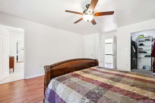 32392 Lodgepole Dr, Evergreen, CO 80439 - bedroom with wood finished floors, connected bathroom, a walk in closet, and ceiling fan