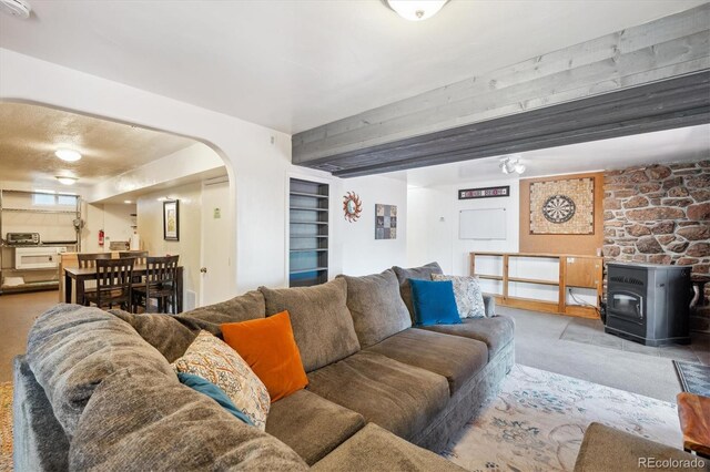 32392 Lodgepole Dr, Evergreen, CO 80439 - carpeted living area with a wood stove and arched walkways
