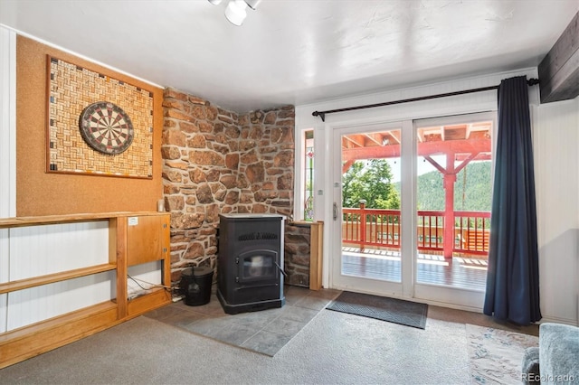32392 Lodgepole Dr, Evergreen, CO 80439 - unfurnished living room with a wood stove and carpet floors