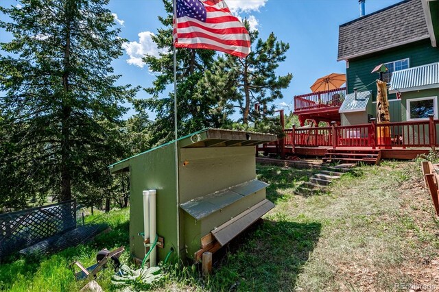 32392 Lodgepole Dr, Evergreen, CO 80439 - view of yard with a wooden deck and an outbuilding